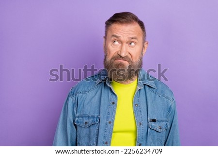 Photo of minded aged person look interested empty space hesitate contemplate isolated on violet color background