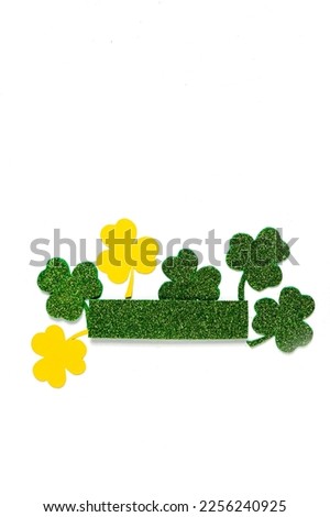 Happy St. Patrick's Day banner.Holiday background.St Patricks Day frame against a white background. Flat lay shamrocks.Copy space.Patrik's day banner Royalty-Free Stock Photo #2256240925