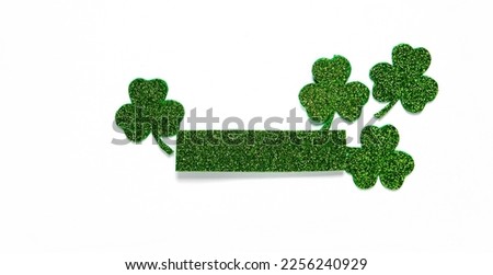 Happy St. Patrick's Day banner.Holiday background.St Patricks Day frame against a white background. Flat lay shamrocks.Copy space.Patrik's day banner Royalty-Free Stock Photo #2256240929