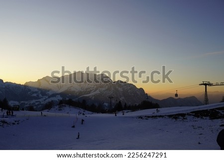 Beautiful sunset with sunrays and ski lift, cable car