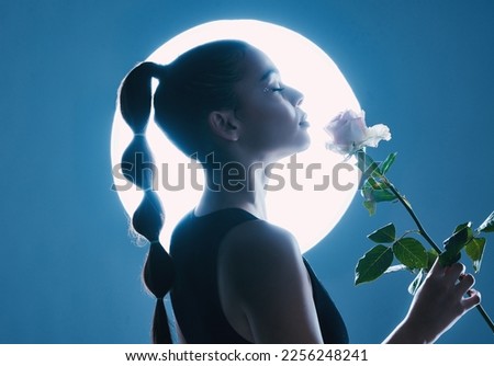 Circle light, art and woman in studio on blue background with flower for dark beauty aesthetic, magic and fantasy. Night, futuristic or creative model person with white rose on moon spotlight mockup