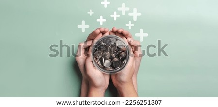 hands of adult and child holding money jar, donation, saving, fundraising charity, family finance plan, inflation, superannuation, investment, retirement concept Royalty-Free Stock Photo #2256251307