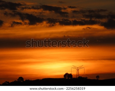 sunset at the site, with vegetation and reddish sky Royalty-Free Stock Photo #2256258319