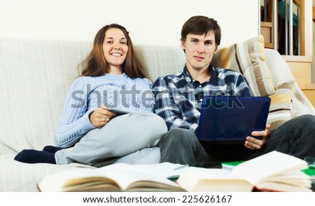Happy couple preparing for exams