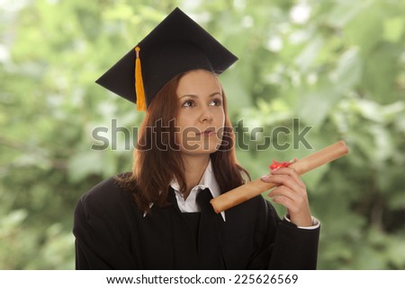 Beautiful woman graduating holding her diploma