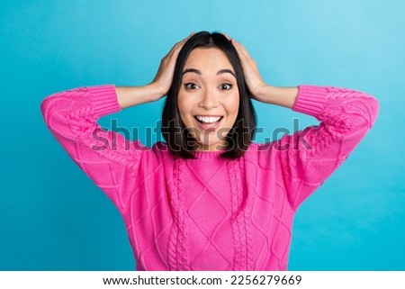 Photo of impressed cheerful indonesian lady hands touch head beaming smile isolated on blue color background