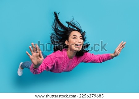 Full length photo of shiny charming woman dressed pink sweater flying falling sky isolated blue color background Royalty-Free Stock Photo #2256279685
