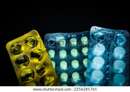 Pills in blisters pack over black background
