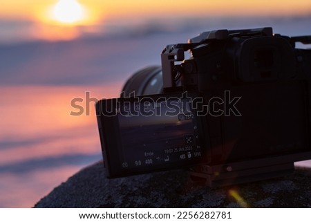 Camera set up to shoot time lapse sunset in winter