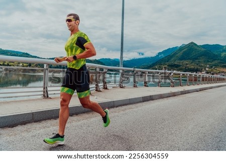 An athlete running a marathon and preparing for his competition. Photo of a marathon runner running in an urban environment