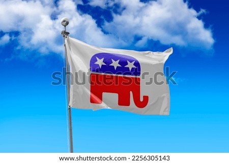 Republican Party US flag flying in a stiff breeze against a clear blue sky. Royalty-Free Stock Photo #2256305143