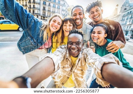 Multiracial best friends taking selfie walking on city street - Happy young people having fun enjoying day out - Diverse teens laughing at camera on summer vacation - Friendship and tourism concept Royalty-Free Stock Photo #2256305877
