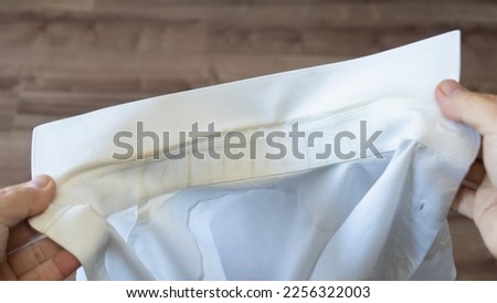 White shirt. Dirt on the collar. Royalty-Free Stock Photo #2256322003