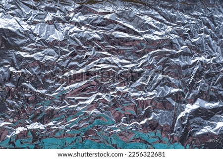 Silver crumpled foil metallic luster holographic effect. High quality photo