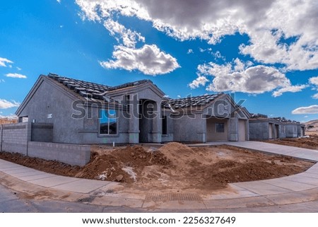 A row of new single family dwellings being finished in Kingman, Arizona. Royalty-Free Stock Photo #2256327649