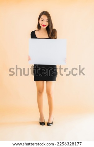 Portrait beautiful young asian woman show empty white billboard on color isolated background
