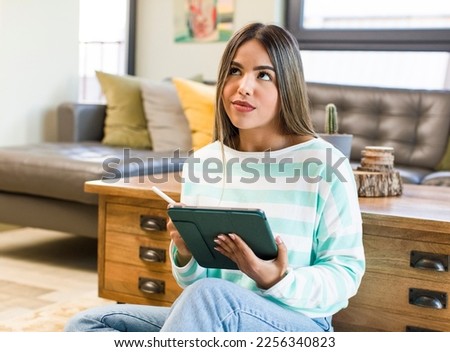 pretty latin woman using a pad at home