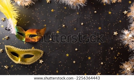 Happy Purim carnival decoration concept made from golden mask and sparkle star on dark background. (Happy Purim in Hebrew, jewish holiday celebrate)