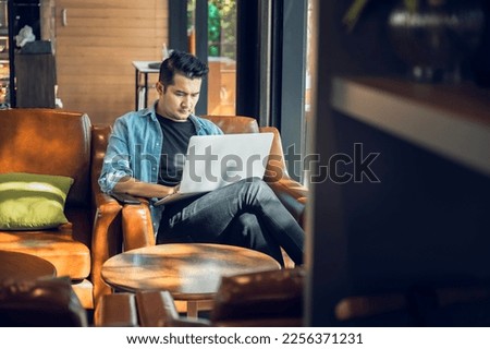 Asian freelancer in blazer with laptop in cafe near window Profession is blogger, freelance translator and writer. Freelance translator works in coffee shop. online learning