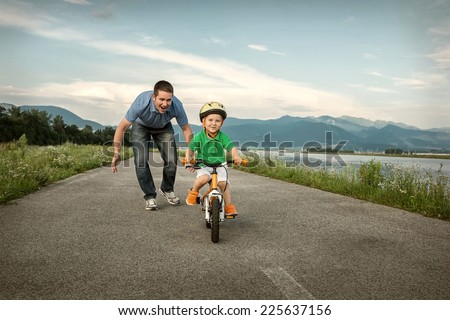 Happiness Father and son on the bicycle outdoor Royalty-Free Stock Photo #225637156