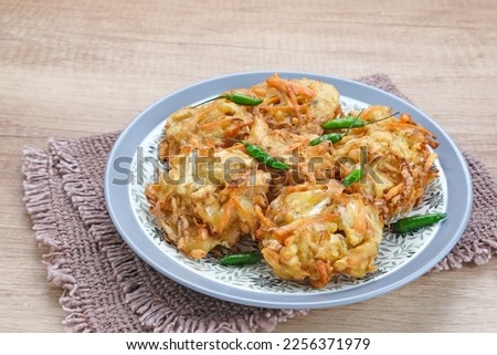 Bakwan sayur or bala-bala or vegetable fritter, Indonesian snack made from flour, cabbage, carrots and bean sprouts, served with chili
 Royalty-Free Stock Photo #2256371979