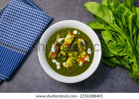 "Palak Paneer" Indian food made of spinach and cottage cheese with a white ceramic plate.  Royalty-Free Stock Photo #2256388401