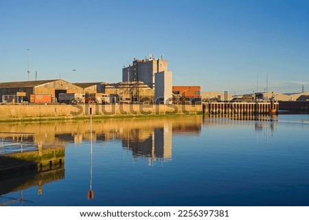 The river Haven with stunning water reflections of Boston Docks with clear blue sky