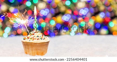 Christmas cupcake decorated with sparkler. Empty space for text.