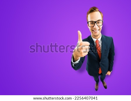 Full body businessman in eye glasses, black suit show thumb up like, agree hand sign gesture, purple background. Comic cartoon style funny man in eyeglasses, big head. Funny face. Expert recommended