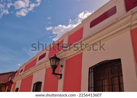 colonial house with sloping street with clear sky