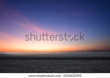 Side view of empty tarmac road with dawn sky background. Royalty-Free Stock Photo #2256420395