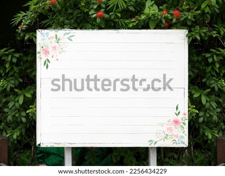 Outdoor white sign with green leaf natural background