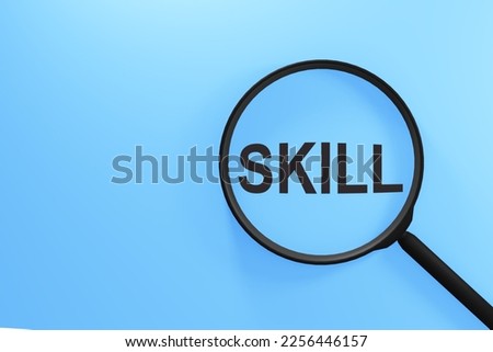 SKILL word through magnifying glass on light blue background