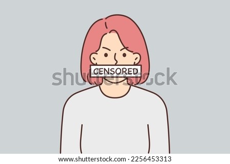 Angry woman with censored sign covering mouth symbolizes violation democracy and lack freedom speech. Girl exposes herself to censored to be tolerant and not offend others Royalty-Free Stock Photo #2256453313