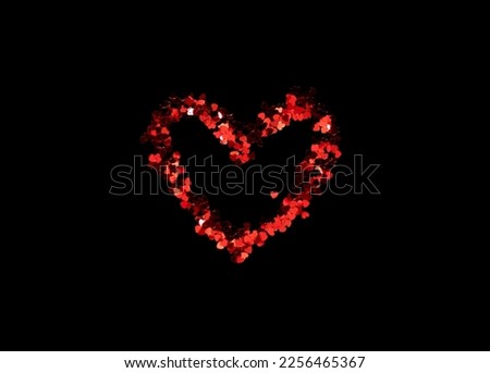 Big red heart shape from small hearts for Valentine's day. the background is black