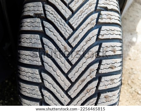 Close-up macro shot of a winter tire covered with dust - brand new wheels for the upcoming cold season - mandatory protection during cold weather