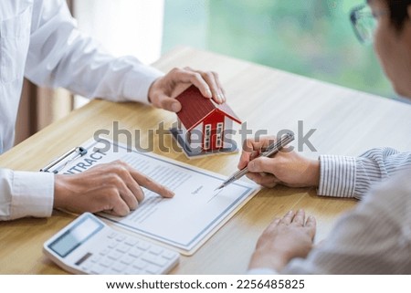 Business people signing contract making deal with real estate agent Concept for consultant home insurance
Real estate investment Property insurance security. Real estate agent offer house.