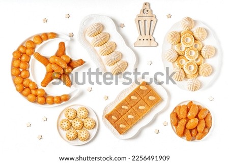  Traditional middle eastern sweets assortment with ramadan decor . Ramadan desserts maamoul, awameh or lokma, basbousa . Top view	                               Royalty-Free Stock Photo #2256491909