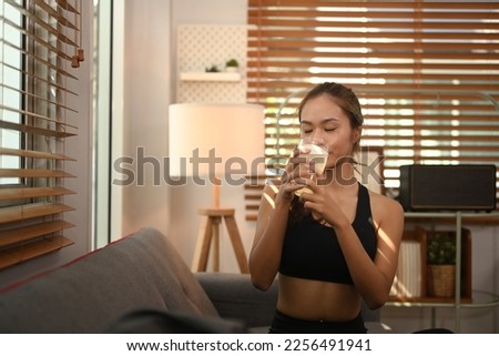 Sporty woman drinking collagen supplements after exercise. Natural supplement for skin beauty and bone health Royalty-Free Stock Photo #2256491941