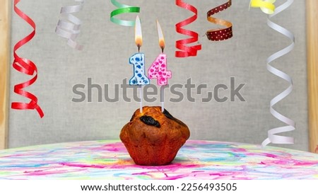 Happy birthday background with muffin with beautiful decorations with number candles  14. Colorful festive card happy birthday with a number. Anniversary copy space