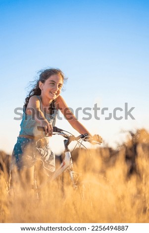 Cute girl with her bike at summer.