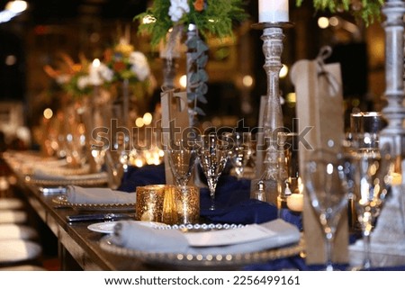 A stylish and elegant decoration with a dark navy blue color theme, prepared for the wedding organization that will take place in the car museum. Royalty-Free Stock Photo #2256499161