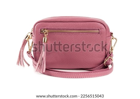 Pink little leather bag on the white background. Modern  hand bag isolated on a white background