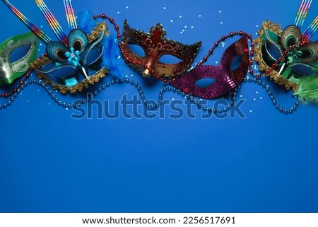 Carnival masks for Mardi Gras celebration with stars and beads on blue background