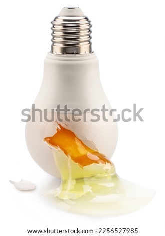 Egg yolk leaking from a light bulb crack - conceptual picture. 