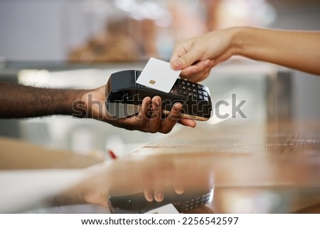 Closeup image of cashier desk worker accepting payment from customer