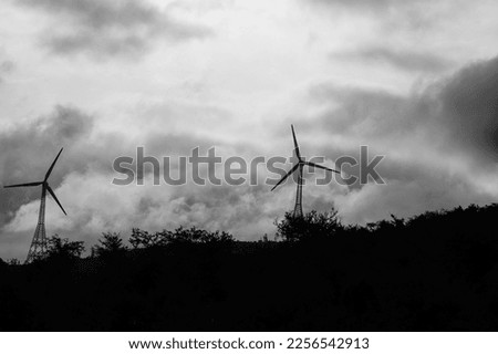 Windmills Black and White Photograph. Windmill is a structure that converts wind power into rotational energy using vanes called sails or blades.