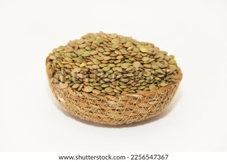 Small round grains of natural green lentils in a decorative plate