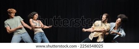 young interracial actors imitating pull rope game in theater, banner