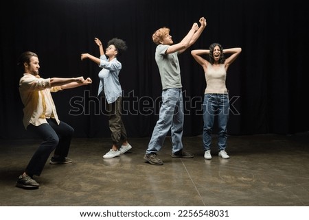 full length of young and emotional students rehearsing in theater school Royalty-Free Stock Photo #2256548031